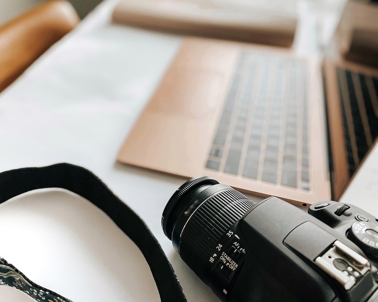 Laptop, camera, desk — Andrew Hillman Supporting Long-Term Success Through Proven Business Practices